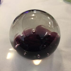 vintage Caithness art glass paperweight in a rich purple and smoke-grey tone with controlled bubbles, similar to designs by Colin Terris