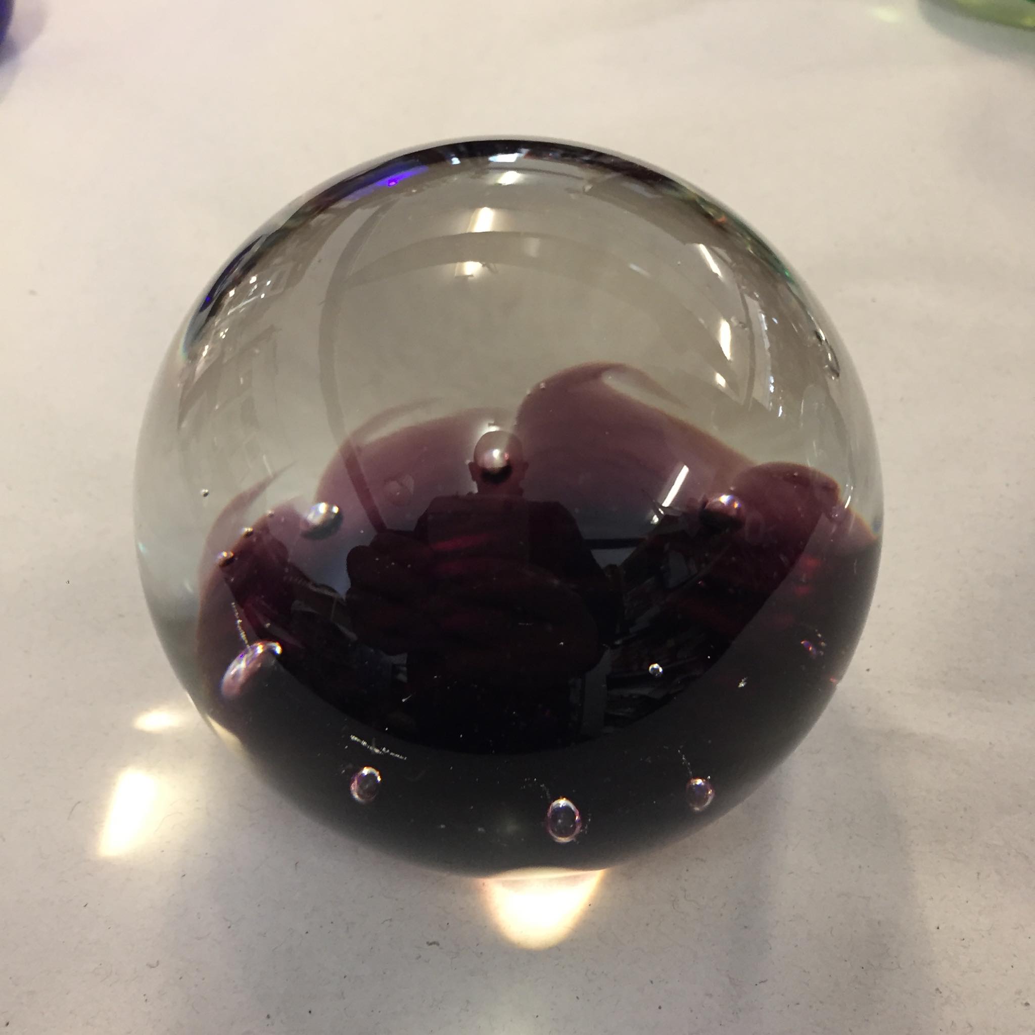 vintage Caithness art glass paperweight in a rich purple and smoke-grey tone with controlled bubbles, similar to designs by Colin Terris